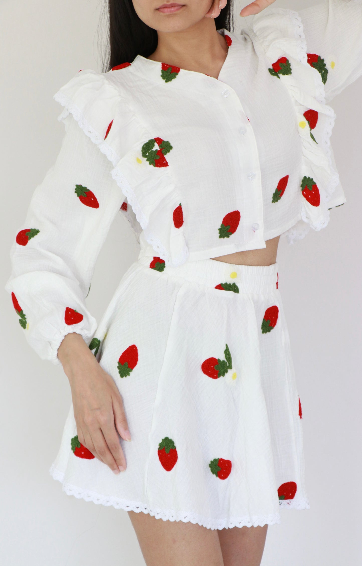 White cotton crop top with strawberry red embroidery, frill details, and matching mini skirt set for summer holidays